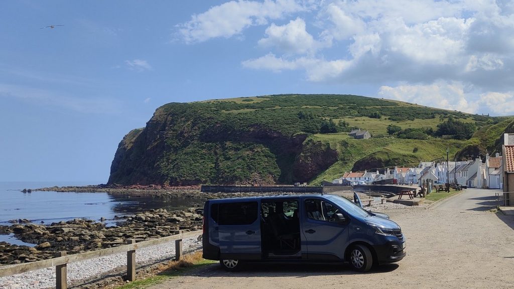My 8 seater Van with the Coastal Village of Pennan in the Background.