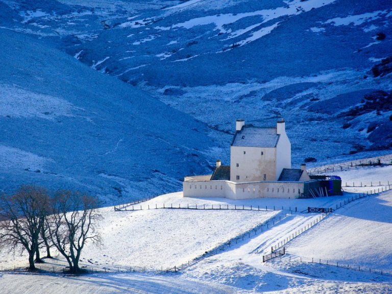 Snowy Scottish castle in a Highland glen