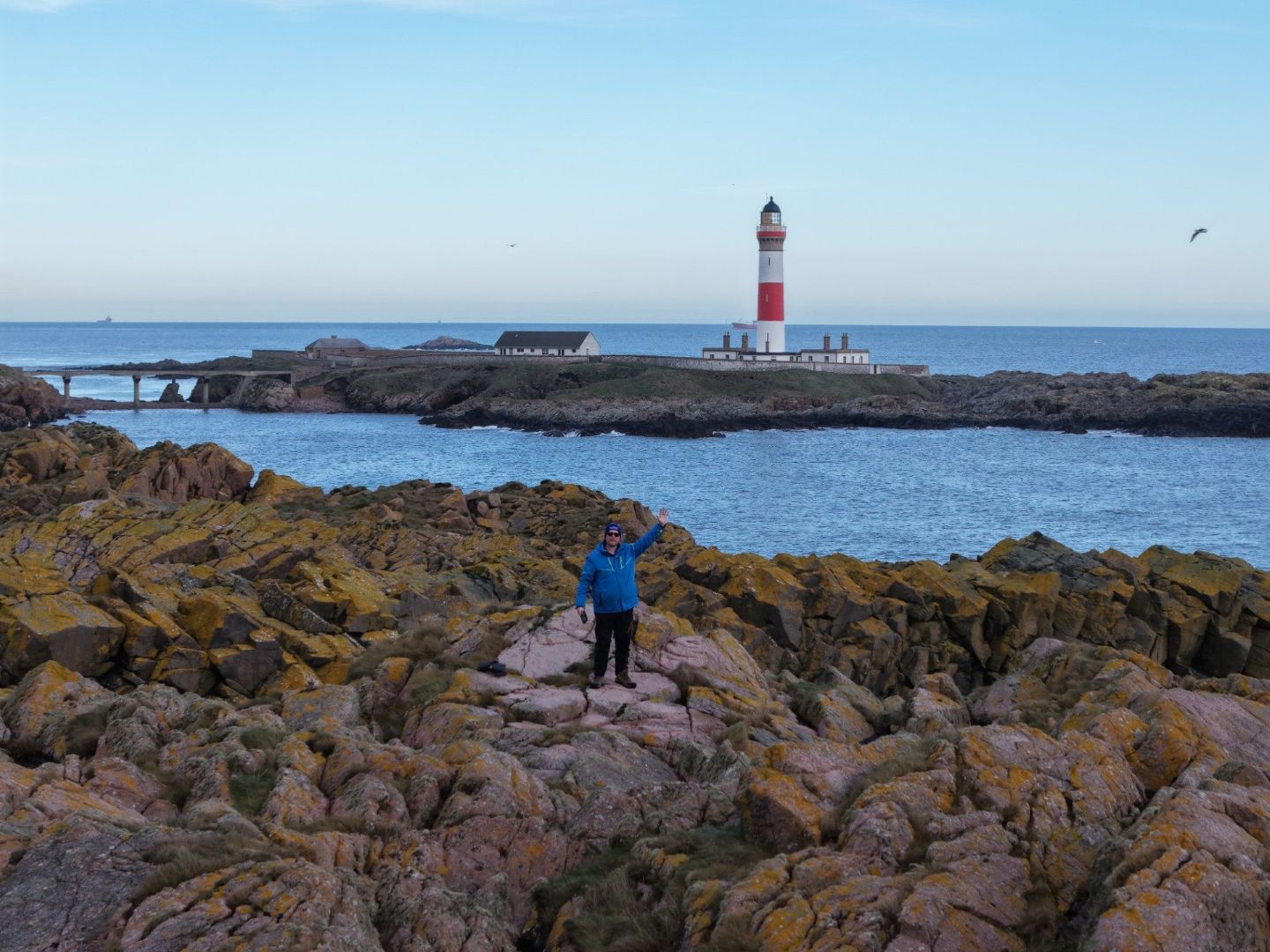 Rattray Head lighthouse seen across rocky shore