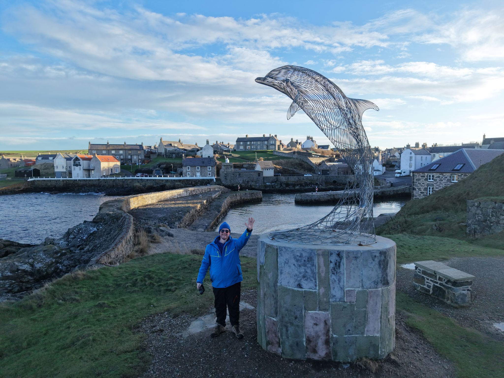 Guide beside a harbour sculpture