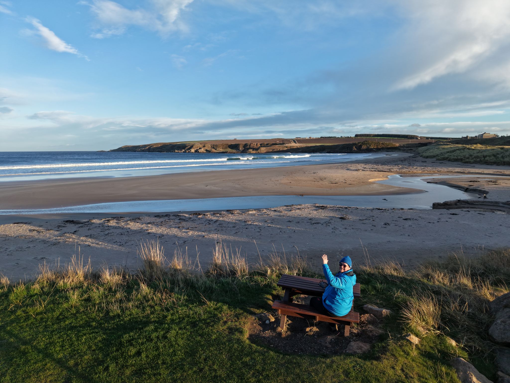 Wide sandy bay and coastal viewpoint